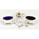 A pair of Edwardian hallmarked silver oval salt cellars, with blue glass liners, Chester 1905,