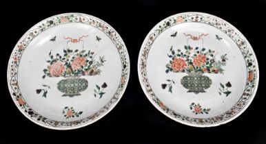 A pair of large Kangxi (1662-1722) Famille Verte chargers, each painted with a central vase of