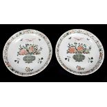 A pair of large Kangxi (1662-1722) Famille Verte chargers, each painted with a central vase of