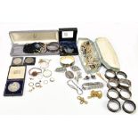 A group of costume jewellery to include two silver bangles, bead necklaces and brooches.