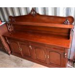 A reproduction Victorian style sideboard, with shelved back above four cushion drawers and two pairs