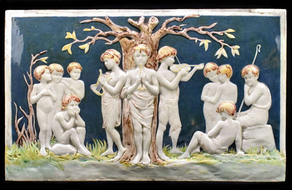 EMILY M. WOOD FOR DELLA ROBBIA; a large earthenware glazed tile decorated with child musicians