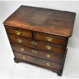 A small Georgian oak and mahogany crossbanded chest of two short and three long drawers on bracket