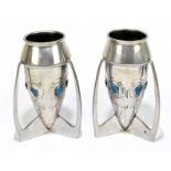 ARCHIBALD KNOX FOR LIBERTY & CO; a pair of pewter and enamel rocket vases, each set with six heat