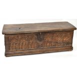 An 18th century blanket box, the hinged lid above a Gothic carved panel front, width 151cm, depth