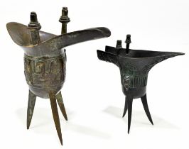 Two Chinese bronze censers of archaic form, each on tripod base, the tallest 17.5cm (2)Additional