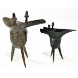 Two Chinese bronze censers of archaic form, each on tripod base, the tallest 17.5cm (2)Additional