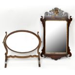 An Edwardian mahogany swing toilet mirror with oval plate, and a fret carved wall mirror (af) (2)