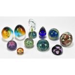 A collection of eleven glass paperweights, including two Mdina examples and a Caithness. (11).