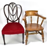 An early 20th century child's oak chair in the form of a Windsor, with solid seat and turned legs,