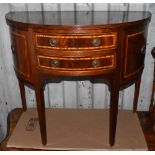 A reproduction mahogany and crossbanded demi-lune cabinet, with two central drawers flanked by