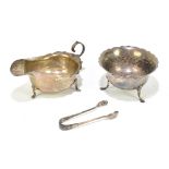 A hallmarked silver sauce boat, Birmingham 1917, with a silver sugar bowl and a pair of tongs 5.5ozt