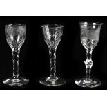 Three 19th century wine glasses comprising two glasses with engraved bowls and faceted stems and a