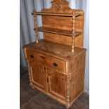 A Continental pine chiffonier, the shelves backed with turned columns above a long drawer and pair