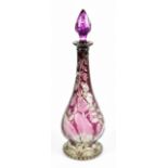 A cut glass amethyst tinted decanter in the style of Webb, height 38cm. Additional