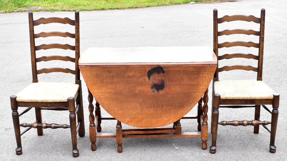 A 1920’s oak gateleg table, on barley twist legs, height 72cm, width 101cm, with four ladder back