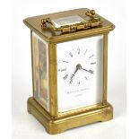 MATTHEW NORMAN; a modern lacquered brass carriage time piece, the enamel dial with Roman numerals,