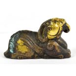 A small Chinese gilt bronze figure of a recumbent animal/mythical beast, probably 17th century,