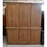 A late 19th century pine housekeeper's cupboard, with an arrangement of six panelled cupboard doors,