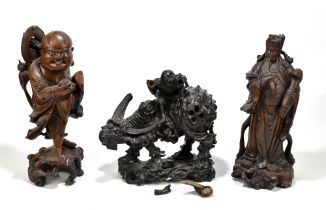 Three Chinese carved hardwood figures, one a boy and a sage with a tortoise and another with an