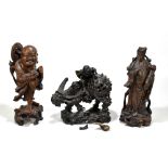 Three Chinese carved hardwood figures, one a boy and a sage with a tortoise and another with an