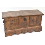 An 18th century stained and carved pine coffer with hinged lid, width 124cm, depth 50cm, height