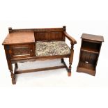 A modern carved oak Old Charm telephone seat with linen fold back and single door, on block feet,