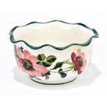 WEMYSS WARE; a footed bowl with wavy rim with pink dot roses, diameter 12cm.