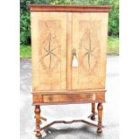 A late 18th century and later German inlaid walnut cabinet on stand, with two doors enclosing a