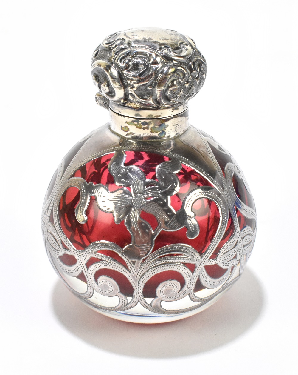 An Edward VII hallmarked silver mounted cranberry glass scent bottle, with floral decoration, with