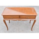 A contemporary two drawer side table, raised on cabriole legs to pad feet, width 102cm.