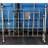 A modern Victorian style silvered metal king size bedstead.