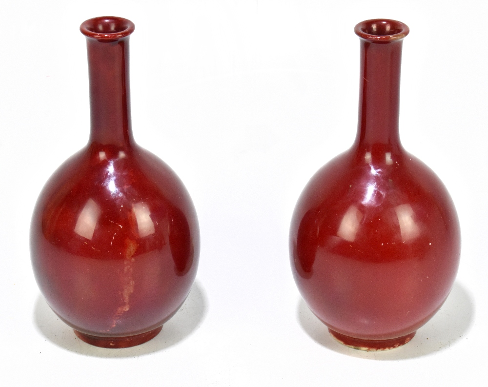 HOWSON; a pair of early 20th century flambé glazed bulbous vases with elongated necks, signed and