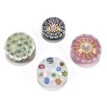 PERTHSHIRE; two glass millefiori paperweights, one with a pink ground and one with a blue ground,