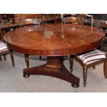 A Victorian mahogany breakfast table with circular tilt-top on triangular column and triform base