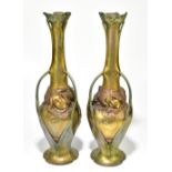 A pair of Art Nouveau bronzed metal three handled vases cast with Art Nouveau maidens and floral