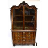 A 19th century Dutch marquetry inlaid display cabinet with shaped moulded cornice and central