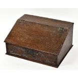 An 18th century oak bible box, carved 1666 AH and with sloping hinged lid, width 63cm, depth 48cm,