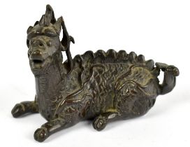 A Chinese late Ming bronze water dropper in the form of a recumbent kylin, his body scaled, base