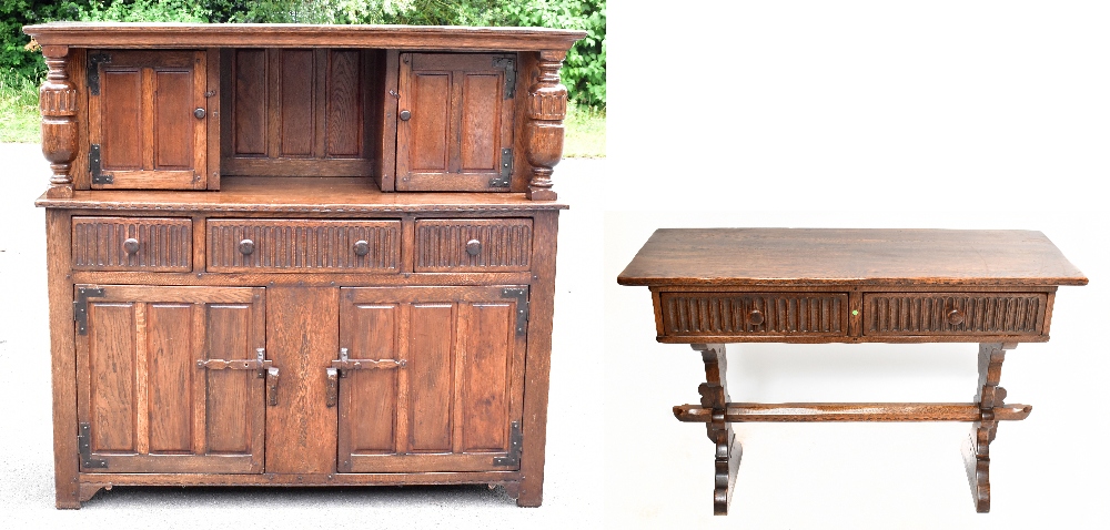 A reproduction oak court cupboard, with panelled door above two drawers and two cupboard doors,