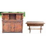 A reproduction oak court cupboard, with panelled door above two drawers and two cupboard doors,