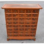 A modern Chinese carved hardwood medicine chest, with an arrangement of forty drawers, on bracket