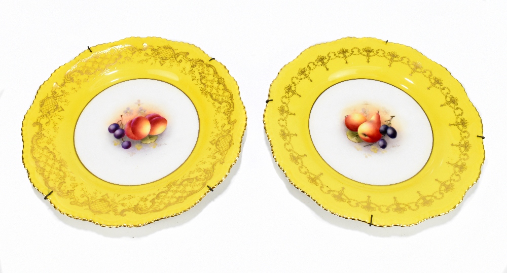 HARRY AYRTON FOR ROYAL WORCESTER; a pair of hand painted cabinet plates with scalloped edges, each