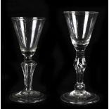 Two 19th century wine glasses each with a knopped stem and folded foot, height of tallest 16cm (2).
