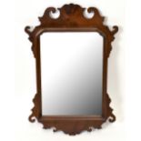 A 19th century walnut Chippendale style fret carved wall mirror, height 65cm.