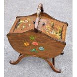 A 1950s oak Chinoiserie decorated sewing cabinet with a pair of pull-up doors enclosing silk lined