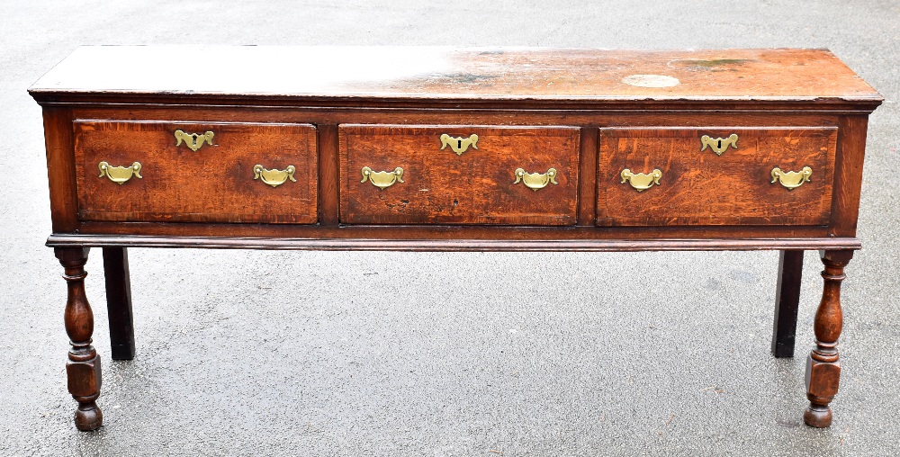 A 18th century oak dresser, the rectangular top above three crossbanded drawers on turned and