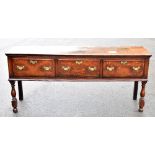 A 18th century oak dresser, the rectangular top above three crossbanded drawers on turned and