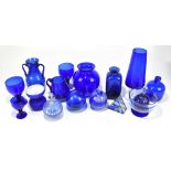 An assortment of contemporary blue glassware including two scent bottles and stoppers, one with
