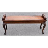 A mahogany window seat, the top with twin scrolled ends and raised on four knee carved cabriole legs